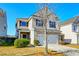 Two-story house with beige siding, black shutters, and a two-car garage at 234 Swamp Creek Ln, Moncks Corner, SC 29461