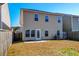 Two-story house with tan siding and backyard at 234 Swamp Creek Ln, Moncks Corner, SC 29461