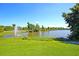 Serene lakefront view with lush landscaping and a water fountain at 234 Swamp Creek Ln, Moncks Corner, SC 29461