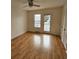 Bright bedroom featuring hardwood floors and a door to the outside at 292 Fleming Rd # C, Charleston, SC 29412