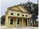 Two story home with light yellow siding, a covered porch, and light blue columns at 2976 Lodge Berry Ln, Johns Island, SC 29455