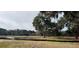 Wooded lot with a pond and a privacy fence surrounding the perimeter at 2976 Lodge Berry Ln, Johns Island, SC 29455