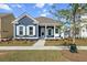 Charming craftsman style home with blue siding, light blue shutters, and a welcoming front porch at 349 Trailmore Ln, Summerville, SC 29486