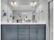 Modern bathroom with double vanity and large mirror at 396 Painted Lady Ln, Goose Creek, SC 29445