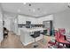Open concept kitchen with white cabinets, quartz countertops, and island seating at 396 Painted Lady Ln, Goose Creek, SC 29445
