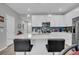 Open concept kitchen with white cabinets, quartz countertops and breakfast bar at 396 Painted Lady Ln, Goose Creek, SC 29445