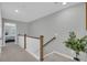 Upstairs hallway with a view of a bedroom and staircase at 396 Painted Lady Ln, Goose Creek, SC 29445