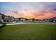 Residential neighborhood with houses and green spaces at sunset at 401 Huckleberry Ct, Summerville, SC 29486