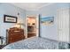 Bedroom with antique dresser and view into kitchen at 45 Sycamore Ave # 523, Charleston, SC 29407