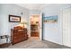 Guest bedroom with antique dresser and view into the kitchen at 45 Sycamore Ave # 523, Charleston, SC 29407