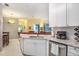 White cabinets, granite counters, and stainless steel appliances in this kitchen at 45 Sycamore Ave # 523, Charleston, SC 29407