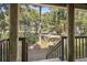 Deck with stairs leading to the yard and view of trees at 4545 Park Lake Dr, Kiawah Island, SC 29455