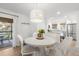 Bright dining area with white table and chairs, view to kitchen and patio at 4545 Park Lake Dr, Kiawah Island, SC 29455
