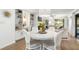 Bright dining room with round table and white chairs, near kitchen at 4545 Park Lake Dr, Kiawah Island, SC 29455