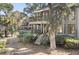 Two-story home with wrap-around porch and stairs at 4545 Park Lake Dr, Kiawah Island, SC 29455
