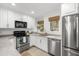 White kitchen with stainless steel appliances and granite countertops at 4545 Park Lake Dr, Kiawah Island, SC 29455