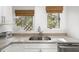 Modern kitchen sink with granite countertop and wood blinds at 4545 Park Lake Dr, Kiawah Island, SC 29455