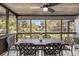 Relaxing screened porch with table and chairs, overlooking wooded area at 4545 Park Lake Dr, Kiawah Island, SC 29455