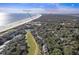 Aerial view of coastal community, showcasing homes, golf course, and ocean at 4995 Green Dolphin Way, Kiawah Island, SC 29455