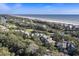 Aerial view of coastal community with oceanfront homes and lush landscaping at 4995 Green Dolphin Way, Kiawah Island, SC 29455