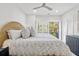 Main bedroom with wicker bed and balcony access at 4995 Green Dolphin Way, Kiawah Island, SC 29455
