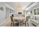 Open concept dining area with round table, chandelier, and living area view at 4995 Green Dolphin Way, Kiawah Island, SC 29455