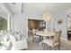 Bright dining room with round table, chandelier, and access to sunroom at 4995 Green Dolphin Way, Kiawah Island, SC 29455