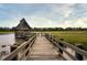 Wooden walkway leading to gazebo over tranquil water at 4995 Green Dolphin Way, Kiawah Island, SC 29455