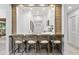 Modern kitchen features white cabinets, breakfast bar, and wood accents at 4995 Green Dolphin Way, Kiawah Island, SC 29455