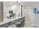 Modern kitchen with white cabinets, breakfast bar, and access to bathroom at 4995 Green Dolphin Way, Kiawah Island, SC 29455