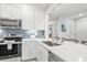 Modern white kitchen with stainless steel appliances and quartz countertops at 4995 Green Dolphin Way, Kiawah Island, SC 29455