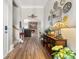 Welcoming foyer with hardwood floors, decorative mirror, and an open view to the living room at 5223 Lenora Dr, Summerville, SC 29485