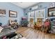 Cozy living room with light blue walls, hardwood floors, and plenty of natural light at 5223 Lenora Dr, Summerville, SC 29485