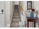 Carpeted stairway with chair lift, wooden handrail, and decorative accents at 5223 Lenora Dr, Summerville, SC 29485