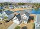 Aerial view of two-story house with attached garage, situated on a lake at 5225 Mulholland Dr, Summerville, SC 29485