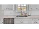 Modern kitchen with white cabinets and a farmhouse sink at 5225 Mulholland Dr, Summerville, SC 29485