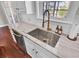 Modern kitchen sink with a gold faucet and large marble countertop at 5225 Mulholland Dr, Summerville, SC 29485