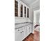 White pantry with glass doors and marble countertop at 5225 Mulholland Dr, Summerville, SC 29485