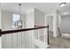 Upstairs hallway with a chandelier and wooden railing at 5225 Mulholland Dr, Summerville, SC 29485