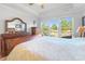 Main bedroom with wood flooring, large windows, and a sleigh bed at 6176 Wilkes Pond Dr, Hollywood, SC 29449