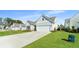 Two-story home with a white garage door and manicured lawn at 6176 Wilkes Pond Dr, Hollywood, SC 29449