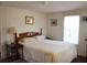 Bright bedroom with a queen-size bed and wood dresser at 6321 Bears Bluff Rd, Wadmalaw Island, SC 29487