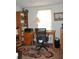 Bright home office with built-in shelving and hardwood floors at 6321 Bears Bluff Rd, Wadmalaw Island, SC 29487
