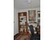 Home office with ample shelving and a view of the garden at 6321 Bears Bluff Rd, Wadmalaw Island, SC 29487