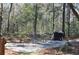 Gravel patio with table and chairs next to a grill at 6321 Bears Bluff Rd, Wadmalaw Island, SC 29487