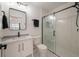 Modern bathroom with white vanity, a frameless glass shower, and grey tile at 7311 Indigo Palms Way, Johns Island, SC 29455