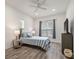 Cozy bedroom with striped bedding, a TV, and hardwood floors at 7311 Indigo Palms Way, Johns Island, SC 29455