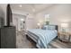Comfortable bedroom with blue and white bedding and an ensuite bathroom at 7311 Indigo Palms Way, Johns Island, SC 29455