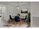 Bright dining area with a round wooden table and four blue chairs at 7311 Indigo Palms Way, Johns Island, SC 29455