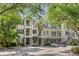 Three-story building with multiple units, balconies, and ample parking at 7311 Indigo Palms Way, Johns Island, SC 29455